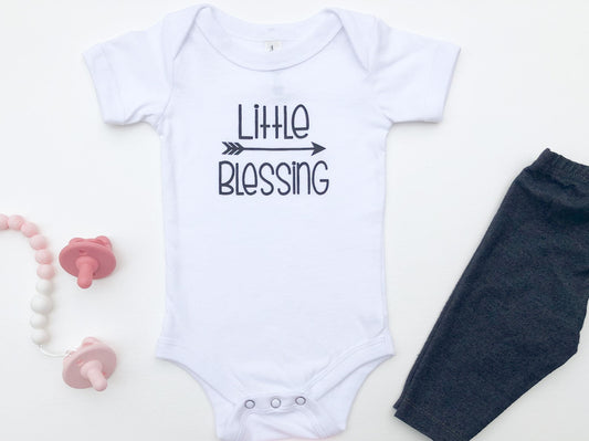 White baby bodysuit with the text Little Blessing