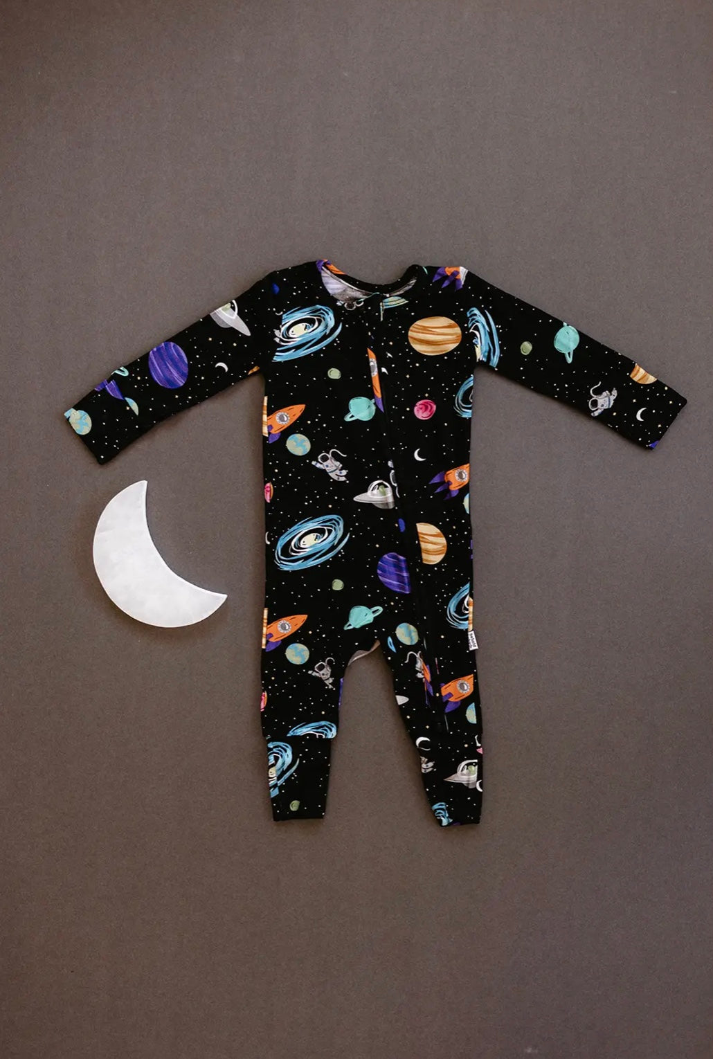 baby boy wearing baby bamboo pajamas romper in black with outer space print