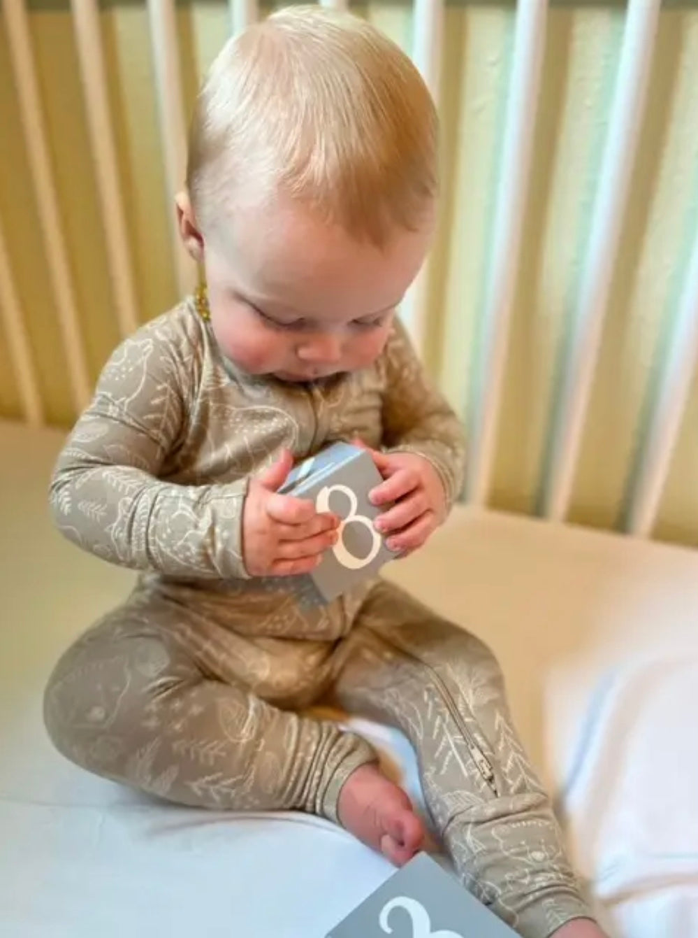 baby boy wearing taupe woodland print baby bamboo pajamas romper