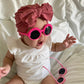 Baby girl wearing pink flower baby sunglasses
