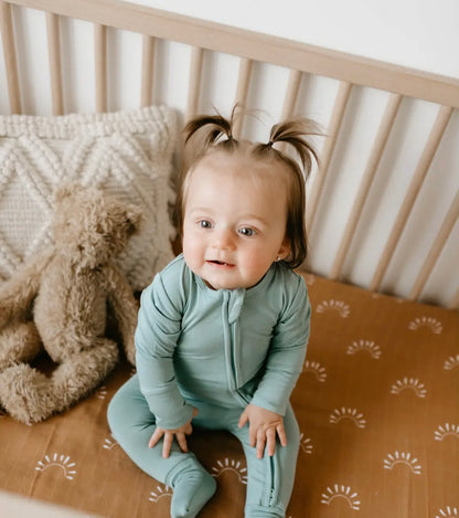 baby girl wearing agave colored baby bamboo pajamas romper