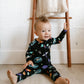 baby boy wearing baby bamboo pajamas romper in black with outer space print